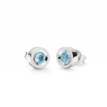 Runde Ohrringe aus rhodiniertem 925er Silber mit einem zentralen, hellblau facettierten Topas-Edelstein und Schnappverschluss.